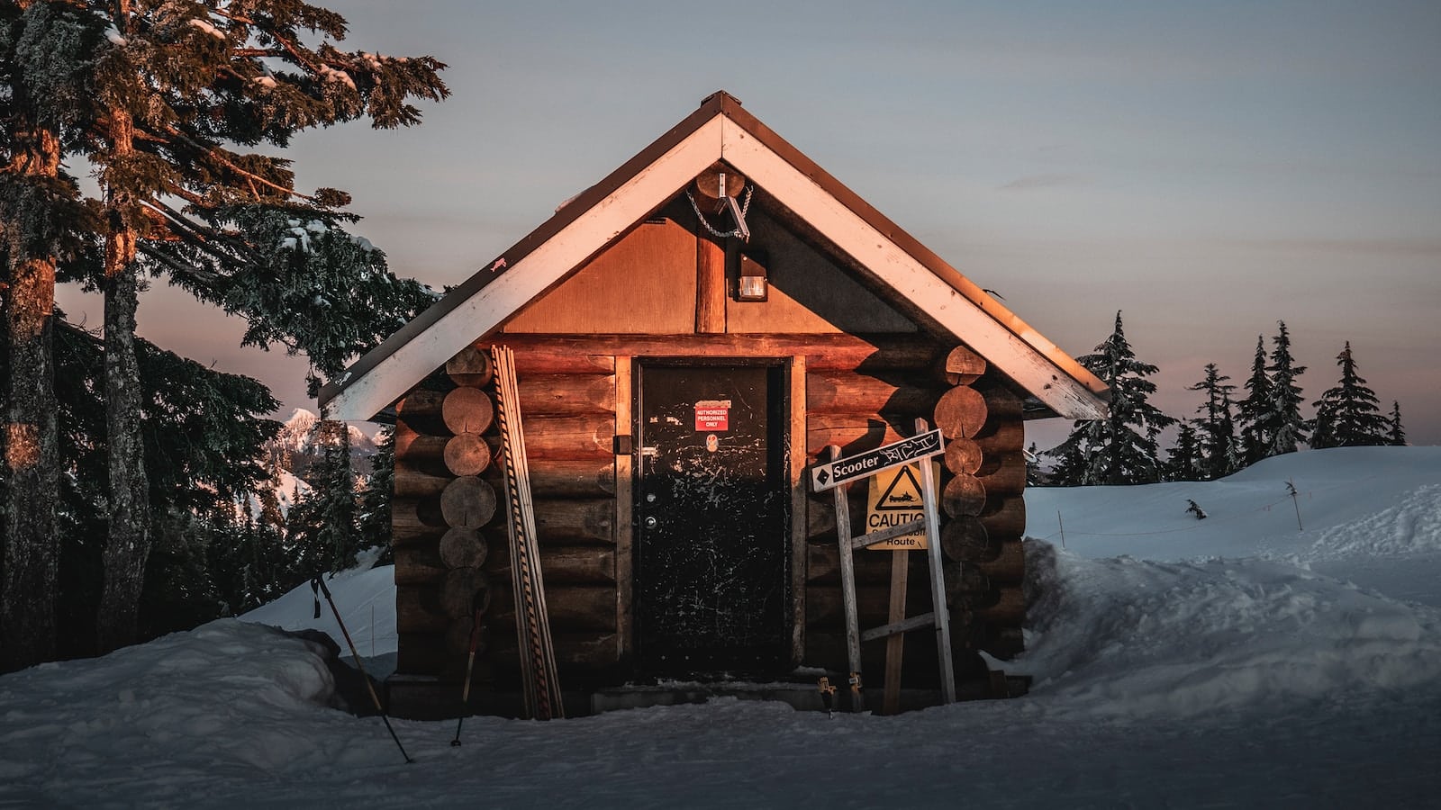 brown wooden house in the middle of icy surface